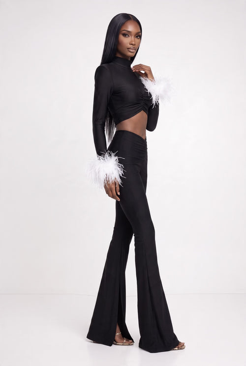 The Saint 54 fitted black crop top with polo neckline, shoulder pads, and detachable white ostrich feather cuffs.