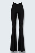 The Saint 54 Muse trousers in black stretch fabric with a high waist, flared legs, and inner seam slits.