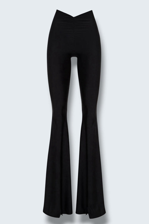 The Saint 54 Muse trousers in black stretch fabric with a high waist, flared legs, and inner seam slits.