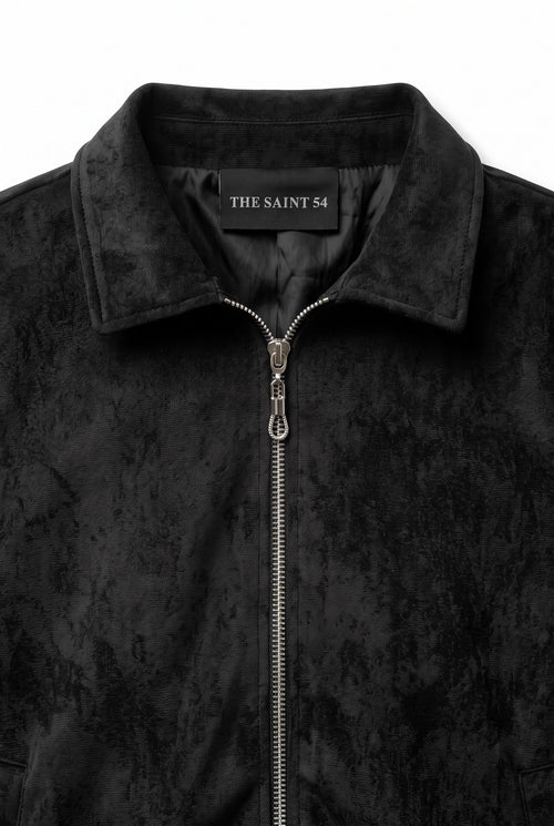 The Saint 54 black suede bomber jacket with an oversize fit, shoulder pads, and satin lining worn by a model.