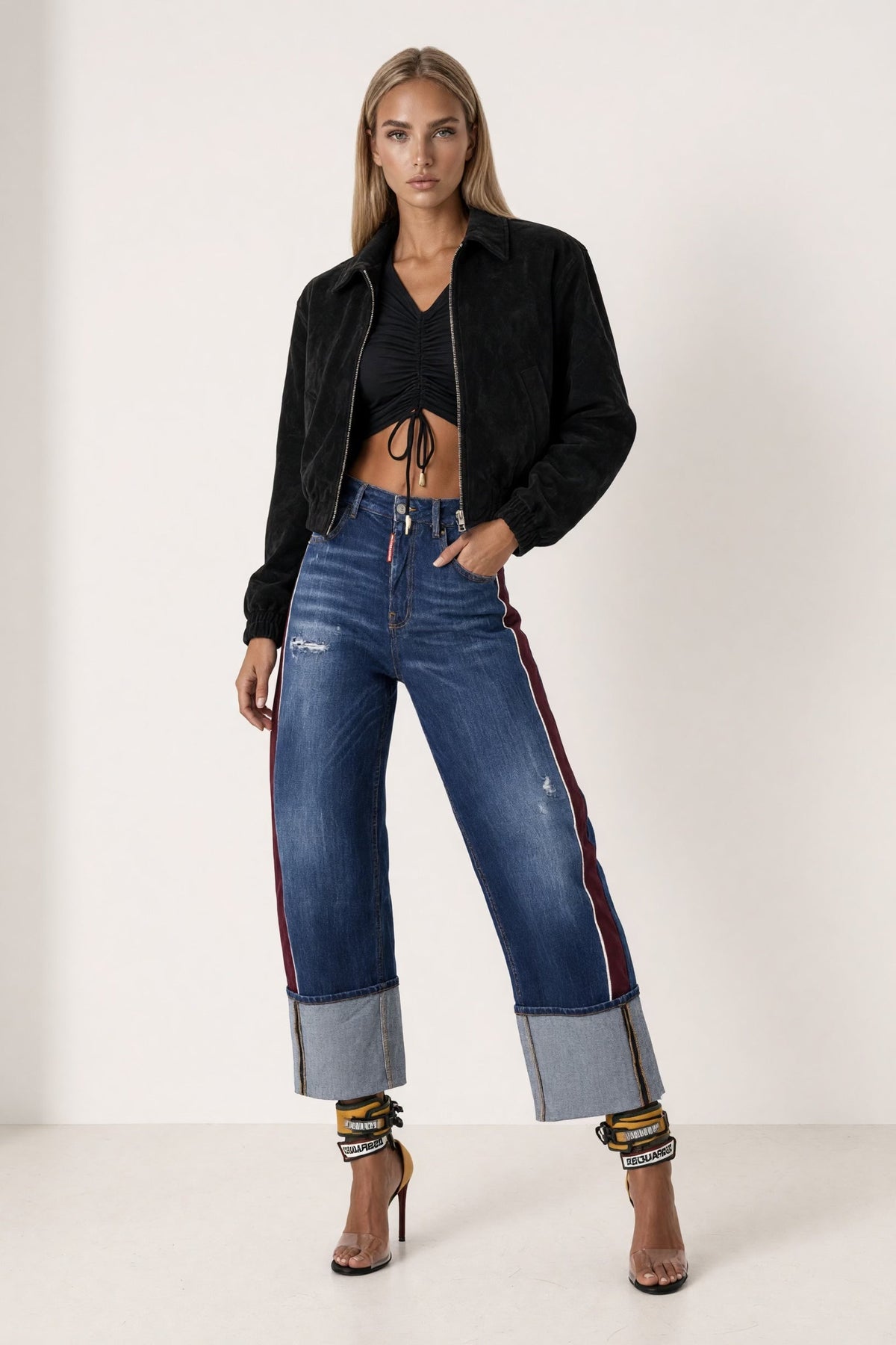 The Saint 54 black suede bomber jacket with an oversize fit, shoulder pads, and satin lining worn by a model.