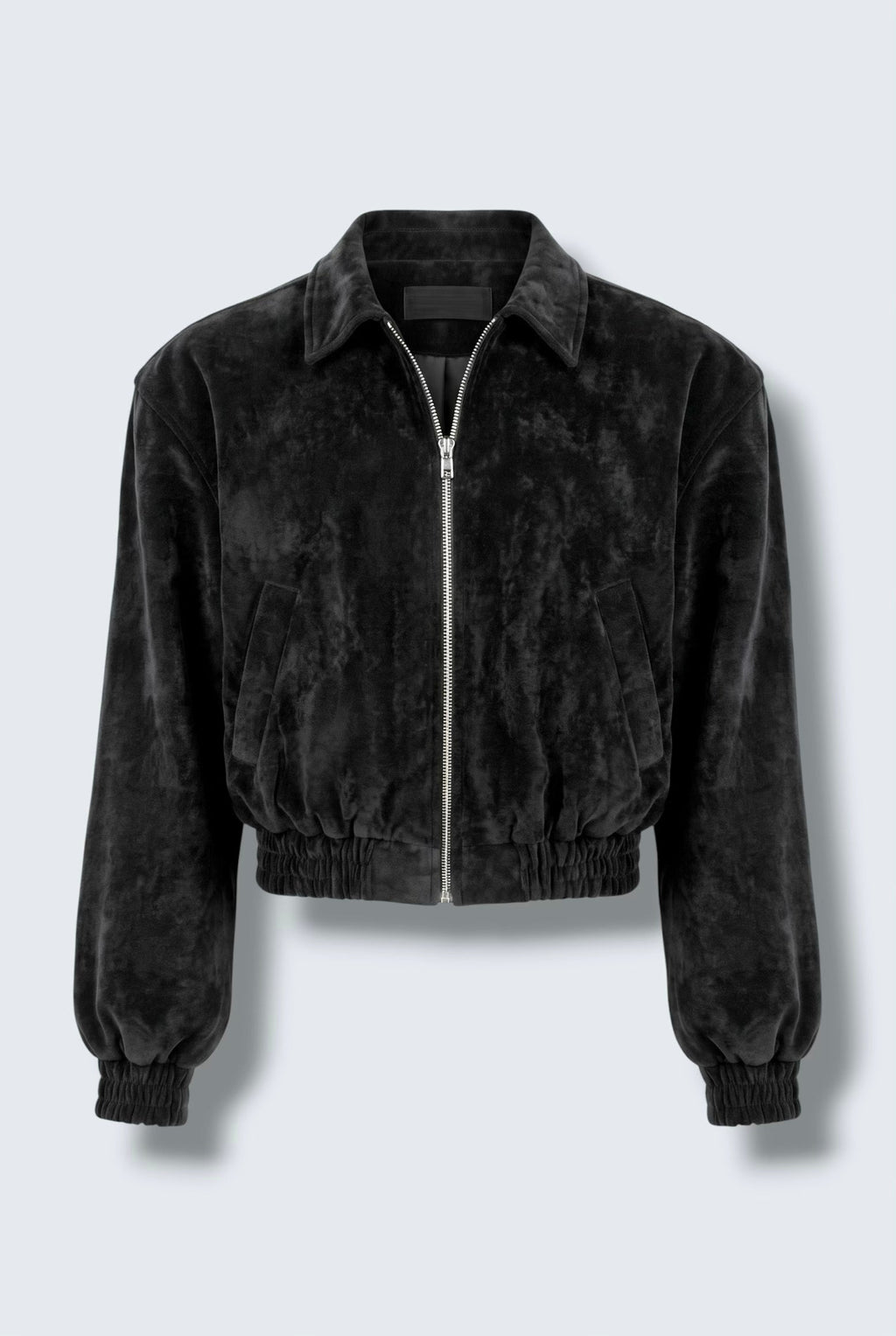 The Saint 54 black suede bomber jacket and ruffled mini skirt set worn by a model against a white background.