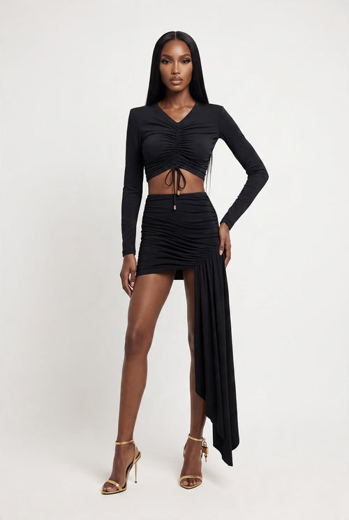 The Saint 54 Miss Rose black long-sleeve crop top featuring elegant ostrich feather cuffs on a model