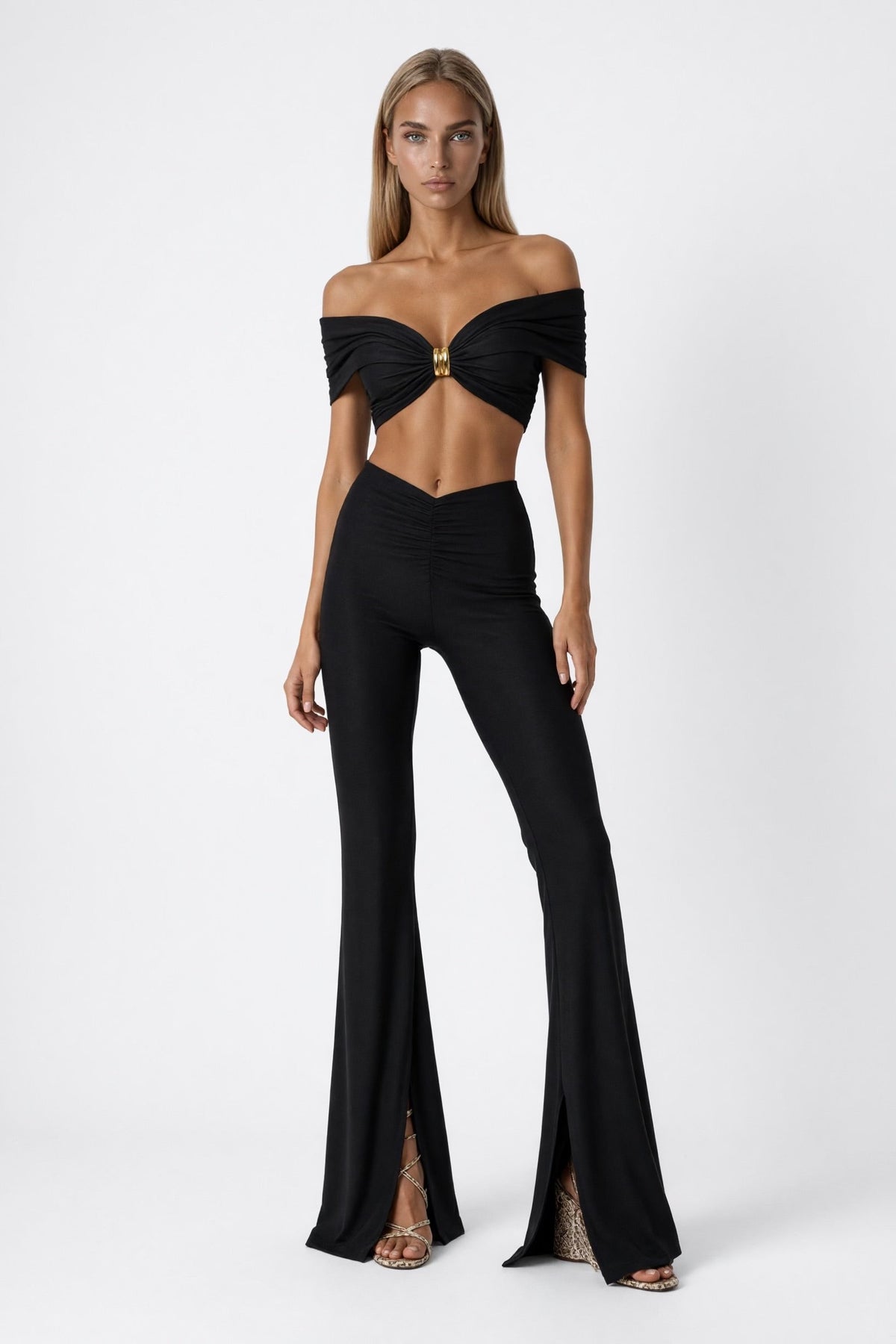 The Saint 54 Muse Trousers in black stretch fabric with a high waist, flared legs, and inner seam slits.